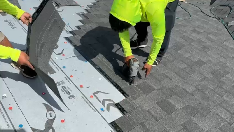 Close-up of shingle installation with nail gun