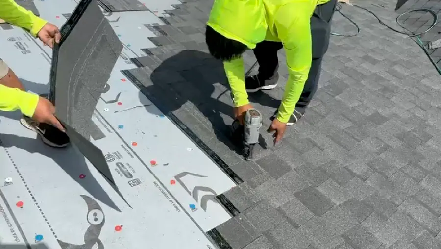 Close-up of shingle installation with nail gun